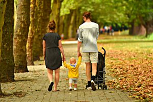 Couple with child taking a stroll through the park