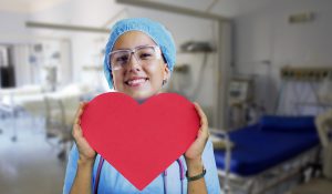 Nurse holding cut our paper heart